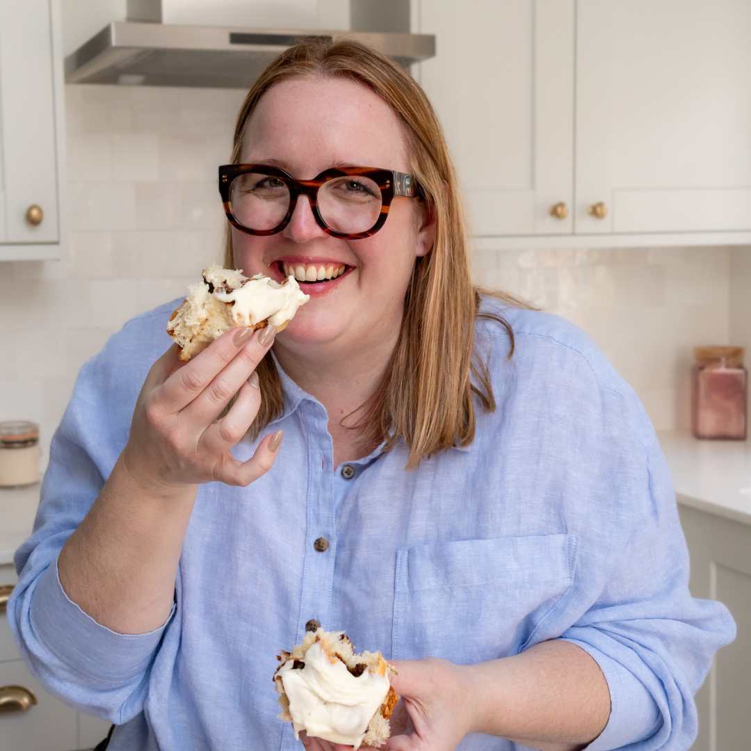 Image of Leah smiling while easting a bun